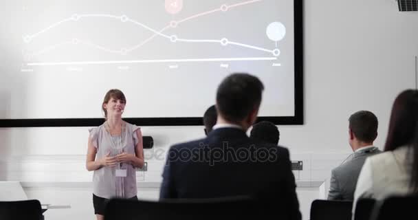 Young female executive speaking at a conference - Footage, Video