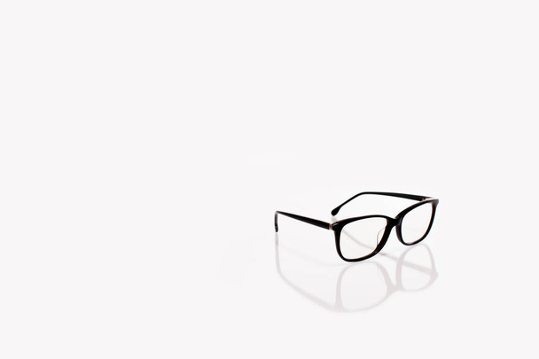 Black eyeglasses with reflection isolated on white background. Sunglasses with transparent lenses - Photo, Image