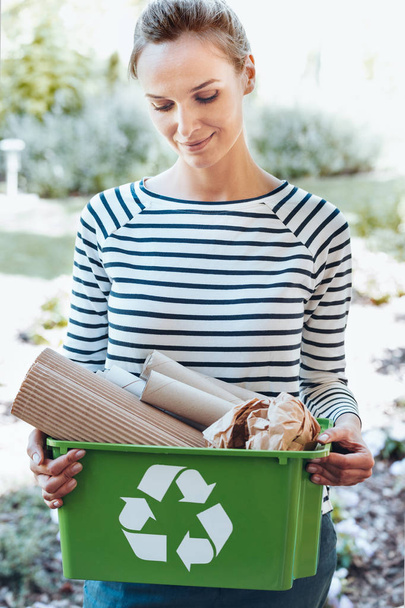 Satisfied housewife using recycling system - Photo, image