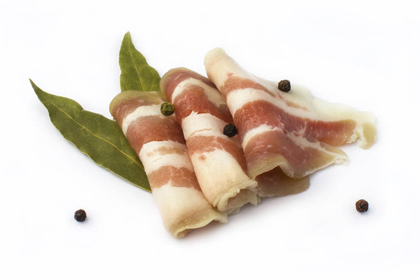 Salted pork lard with spices on a white background. Sliced bacon. isolated  - Foto, Bild