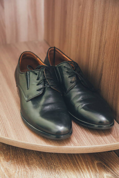 a pair of black men's shoes - Фото, изображение