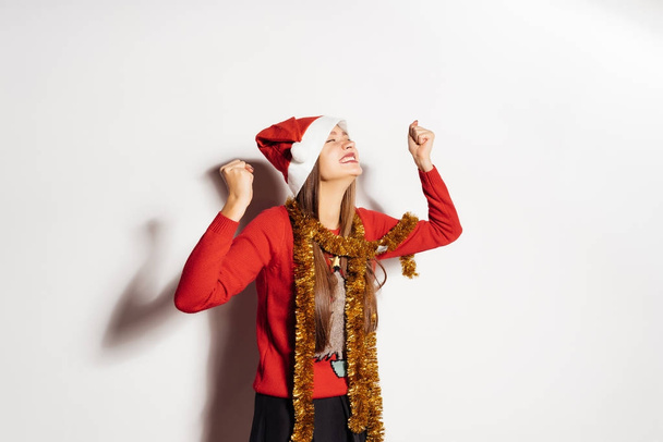 happy young girl is happy, in red clothes, celebrates the new year 2018 and Christmas - Photo, image