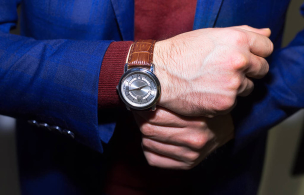 Lifestyle photo of elegant businessmen wearing luxury watch.Successful man.Dark blue suit and red wool sweater. - Photo, Image