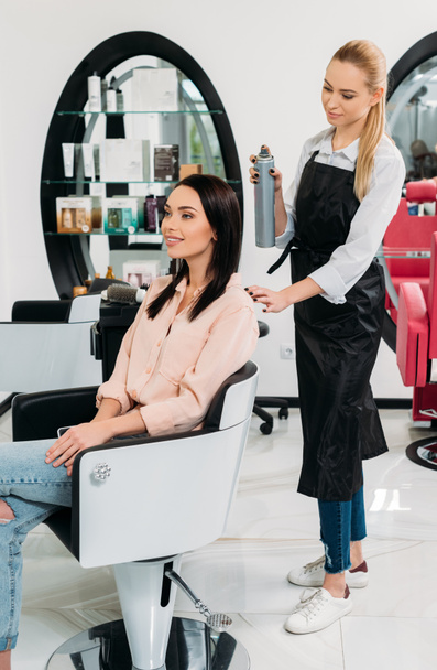 hairdresser looking at new hairdo of customer - Zdjęcie, obraz