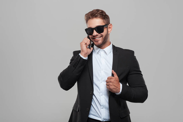 Confident classy man speaking on phone - Foto, imagen
