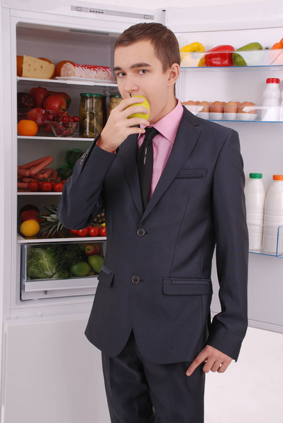 Teenager boy in suit and tie near the refrigerator - Foto, Imagem