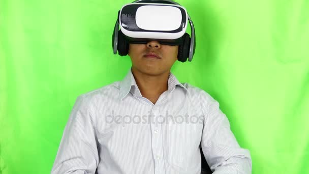 Man wearing virtual reality goggles in Studio shot on green background, - Footage, Video