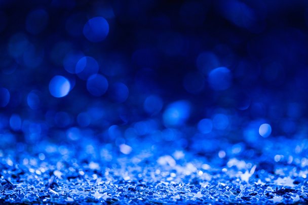 christmas background with blue blurred shiny confetti stars  - Photo, Image
