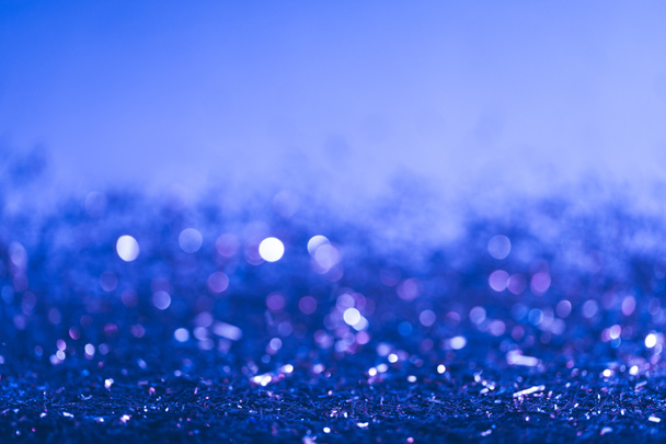 Kerstmis achtergrond met blauwe wazig glanzende confetti  - Foto, afbeelding