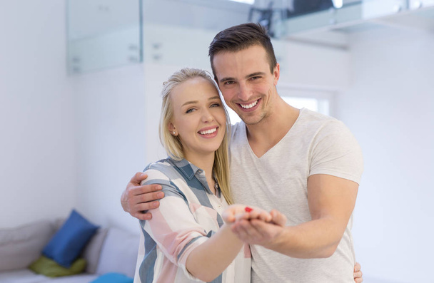 couple showing small red house in hands - Photo, image