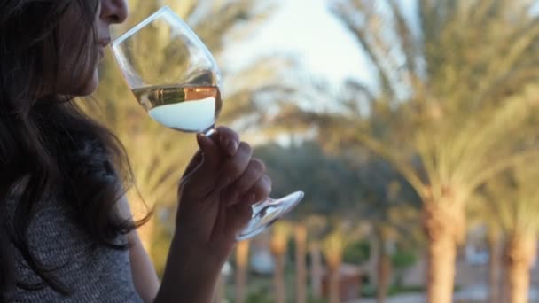 Young woman drinking white wine on outdoor terrace . Travel vacation in Sinai, Egypt. - Footage, Video