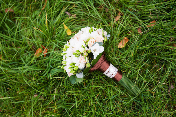 beautiful wedding flowers bouquet on the green grass - Photo, Image