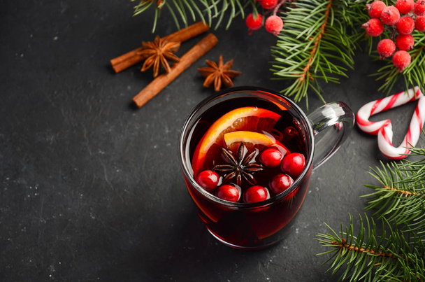 Christmas Mulled Wine with Orange and Cranberries. Holiday Concept Decorated with Fir Branches and Spices. Selective focus, copy space. - Zdjęcie, obraz