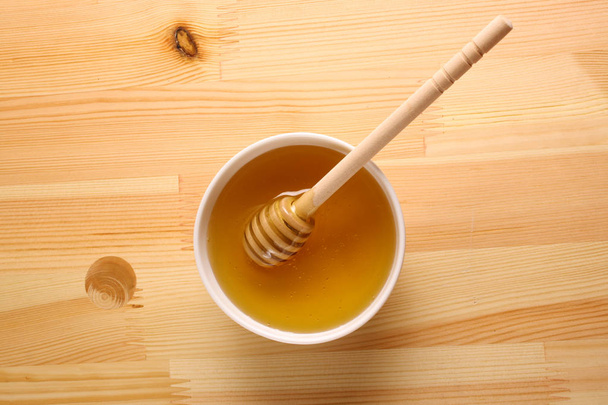 Honey on a wooden background - Valokuva, kuva