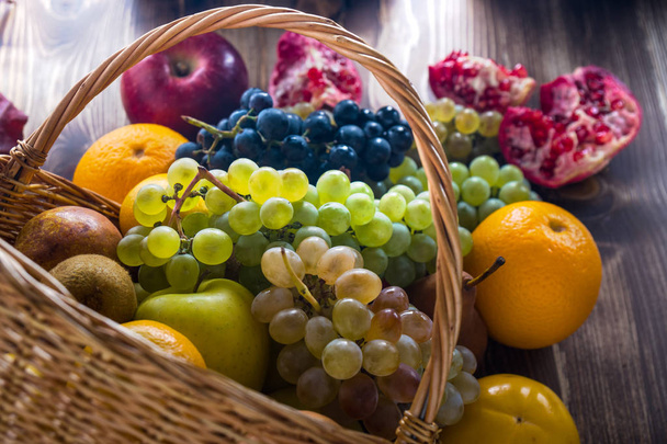 Composition with assorted fruits in wicker basket, healthy life - Photo, Image