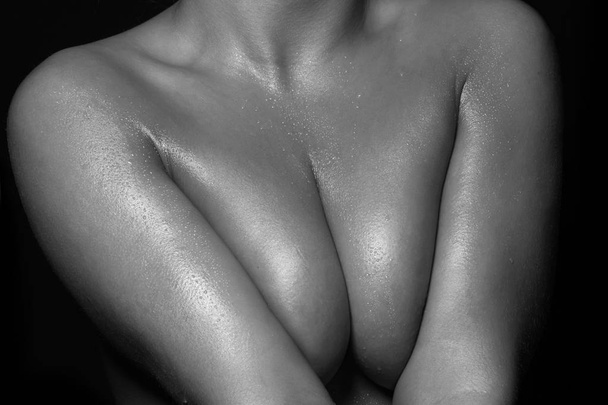 female breast on a black background - Photo, Image