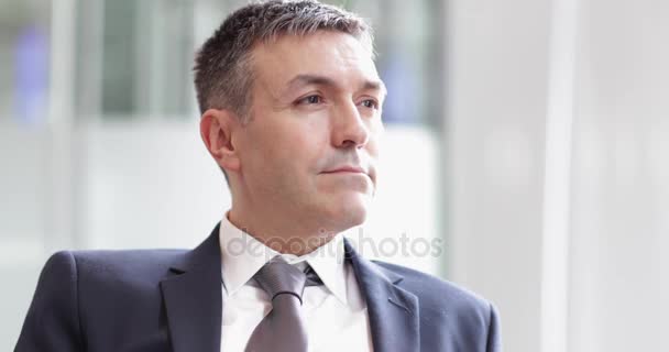 Portrait of successful businessman at office - Кадри, відео