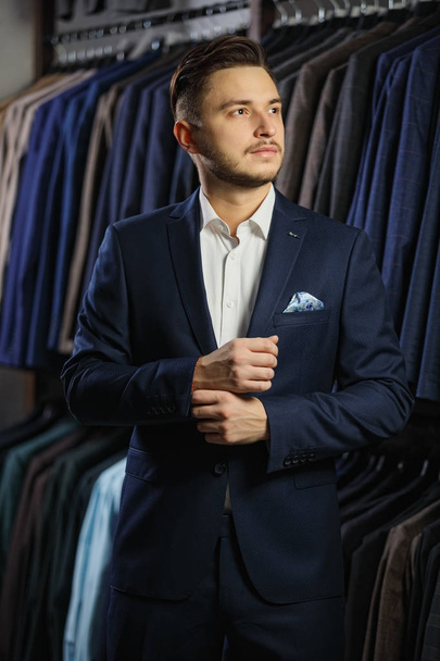 Handsome caucasian businessman dressed in the suit in suit shop - Photo, image