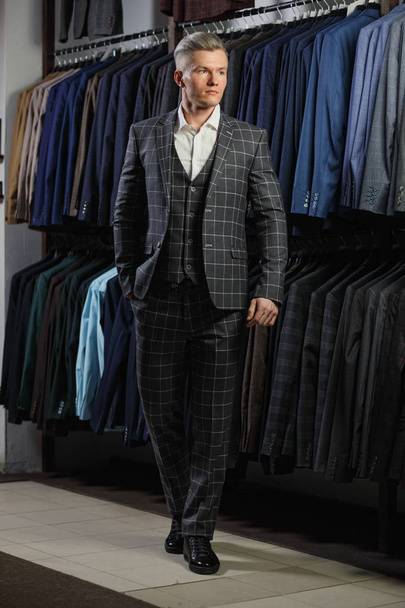 Handsome caucasian businessman dressed in the suit in suit shop - Foto, Bild