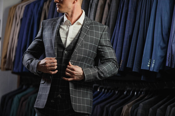 Handsome caucasian businessman dressed in the suit in suit shop - Photo, image