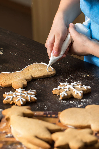 kids hand decorating cookies with sugar. - Photo, image