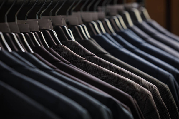 Rows of mens suit jackets in suitshop - Фото, изображение
