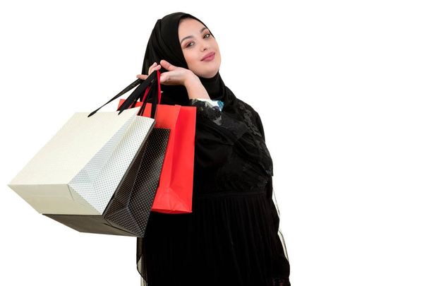 Arabian woman carrying shopping bags isolated on white - Φωτογραφία, εικόνα