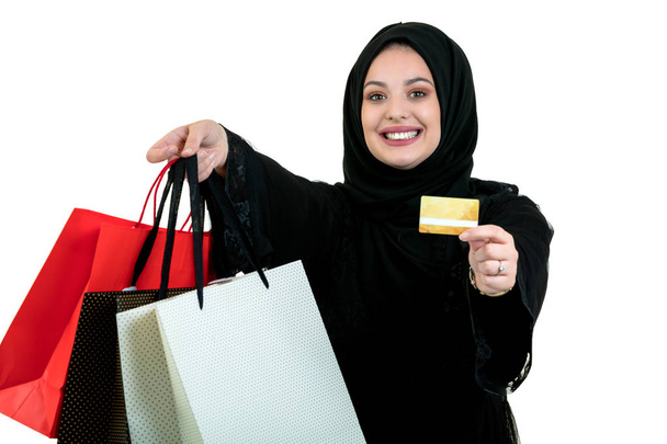 Arabian woman carrying shopping bags isolated on white - Fotografie, Obrázek