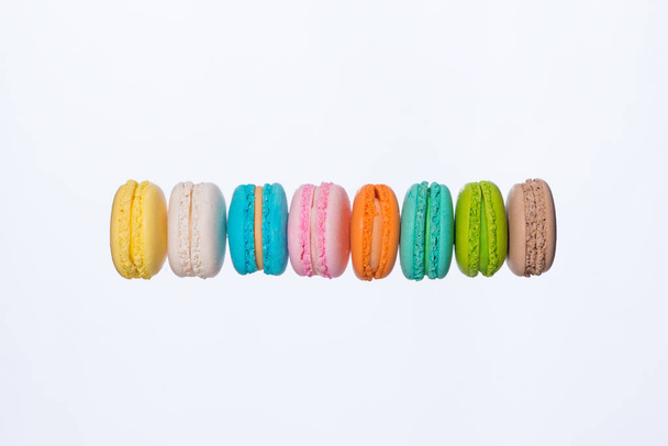Colorful macarons cakes. Sweet french macaroons flying in motion. - Foto, immagini