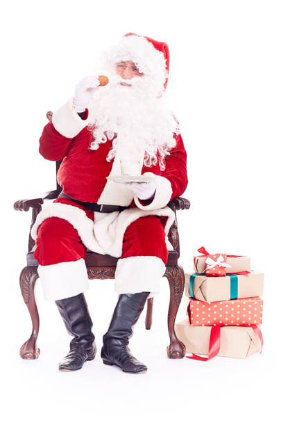 Santa eating cookies - Foto, afbeelding