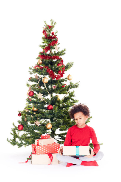 Mixed race boy near Christmas tree - Foto, immagini