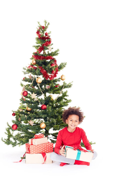 Mixed race boy near Christmas tree - Foto, immagini