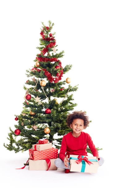 Mixed race boy near Christmas tree - Φωτογραφία, εικόνα