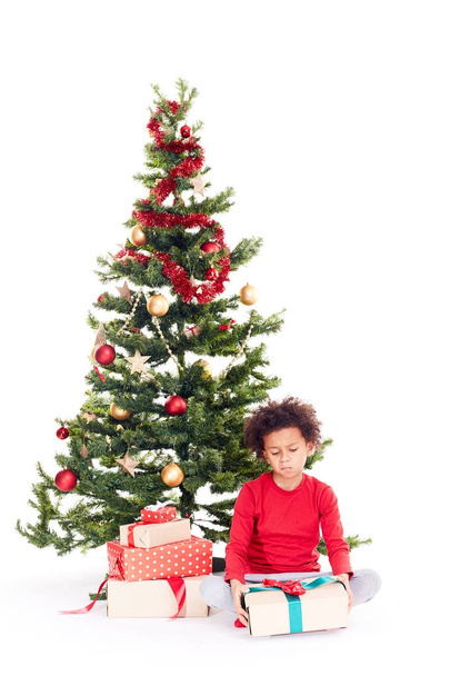 Mixed race boy near Christmas tree - Fotografie, Obrázek