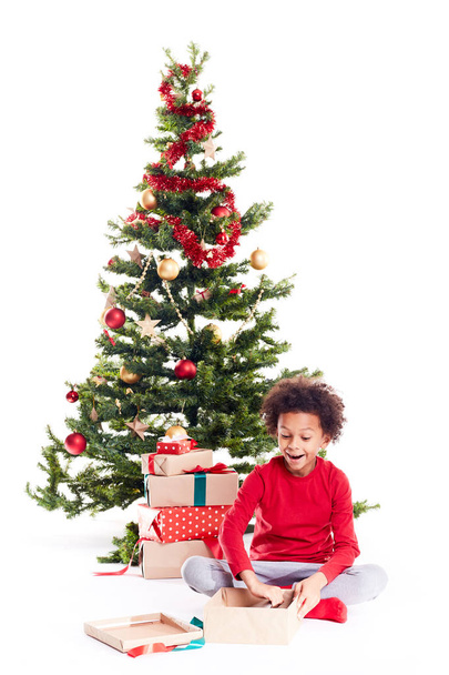 Boy unpacking Christmas gifts - Foto, immagini