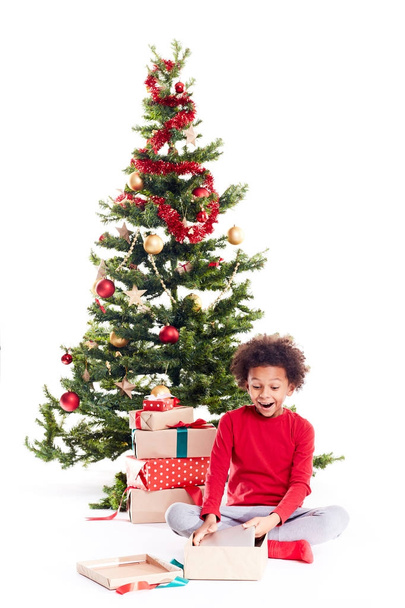 Boy unpacking Christmas gifts - Фото, изображение