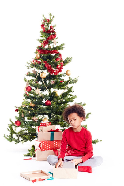 Boy unpacking Christmas gifts - Foto, Imagem