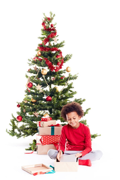 Boy unpacking Christmas gifts - Фото, зображення