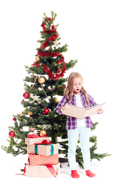 Girl near Christmas tree - Фото, зображення