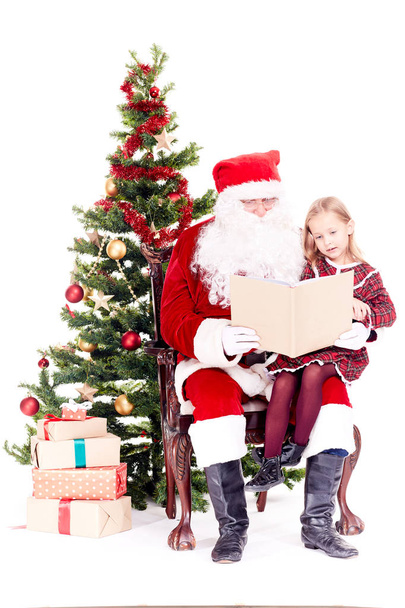 Santa reading story for cute girl - Foto, Imagen