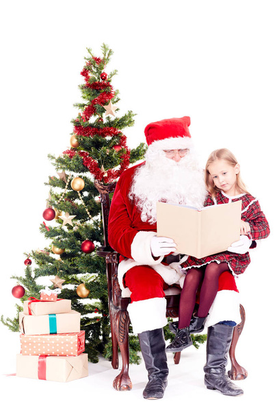 Santa reading story for cute girl - Zdjęcie, obraz