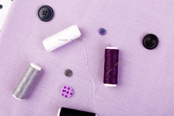 Items for sewing clothes. Sewing buttons, spools of thread and cloth. Top view. - Foto, immagini