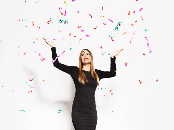 Young woman celebrating, confetti falling - Valokuva, kuva