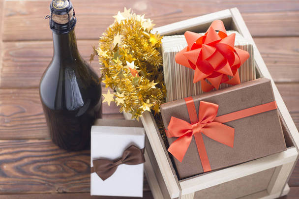 New year surprise in a box with a bottle of champagne and gifts - Fotó, kép