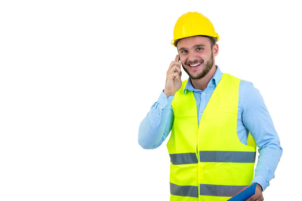 Angry upset young construction engineer yeling at the phone - Фото, изображение