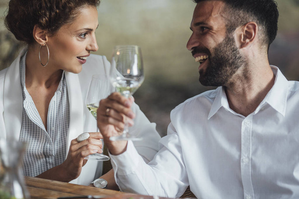 Couple Enjoying Wine and Food at Restaurant - Foto, afbeelding