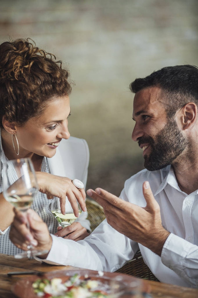 Couple Enjoying Wine and Food at Restaurant - Fotoğraf, Görsel
