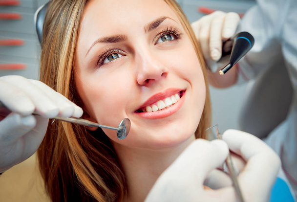 Young smiled woman at the dental office. Medical equipment - Photo, Image
