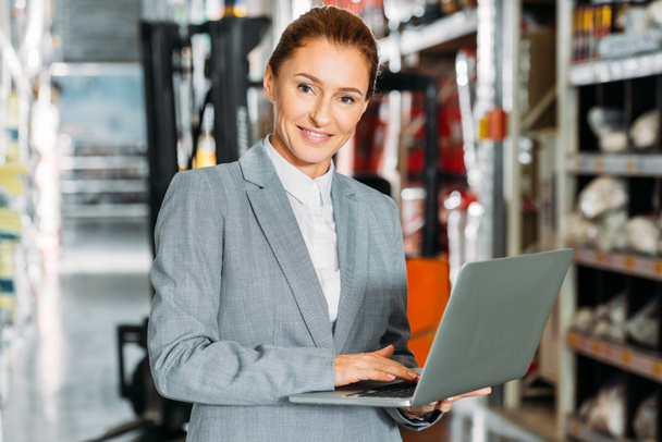 businesswoman using laptop in shipping stock - Photo, Image