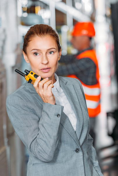female inspector with walkie talkie in shipping stock - Φωτογραφία, εικόνα